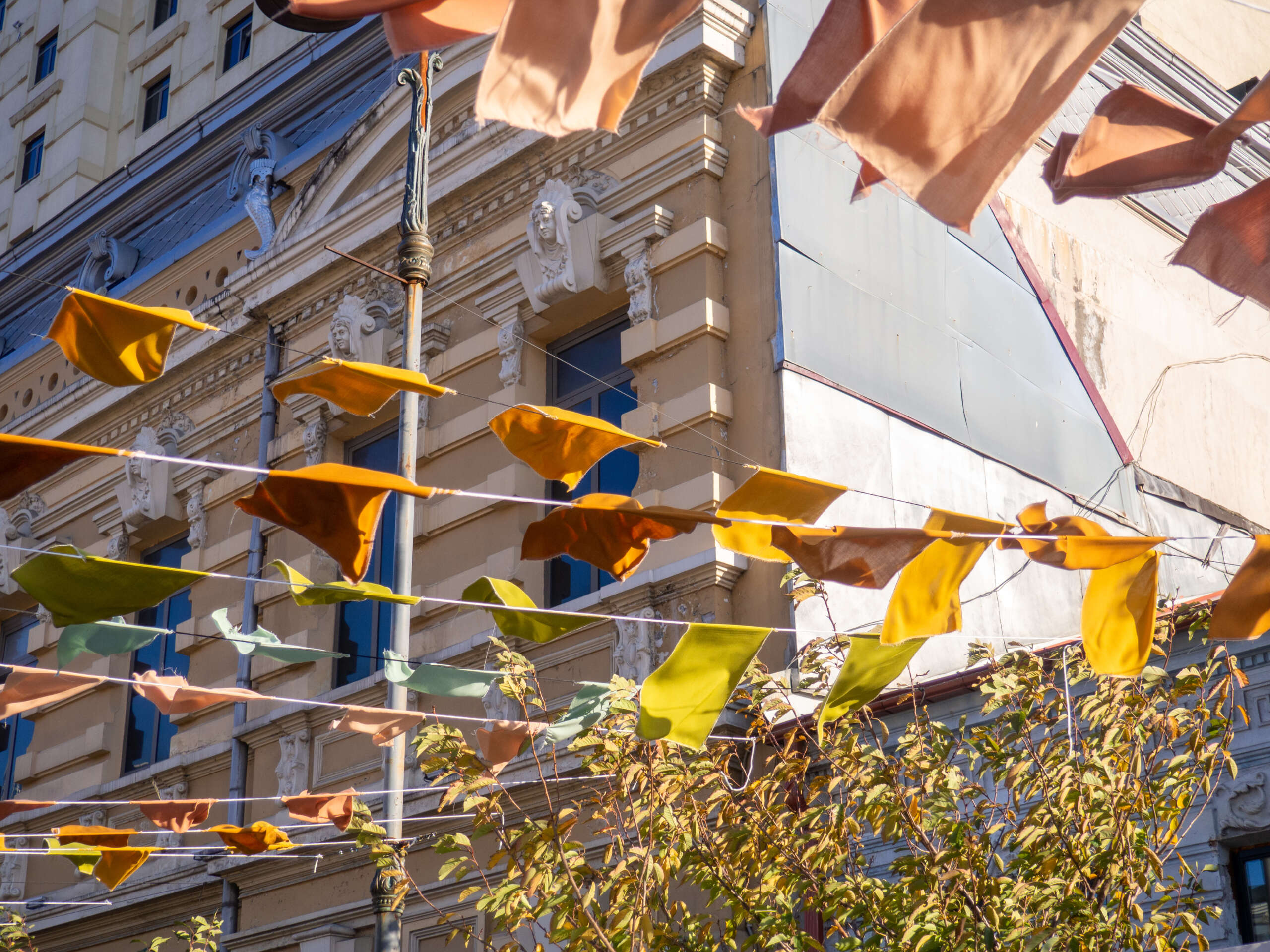 Flags over the street. City celebration concept. Warm colors. Scenery over the street. Festival